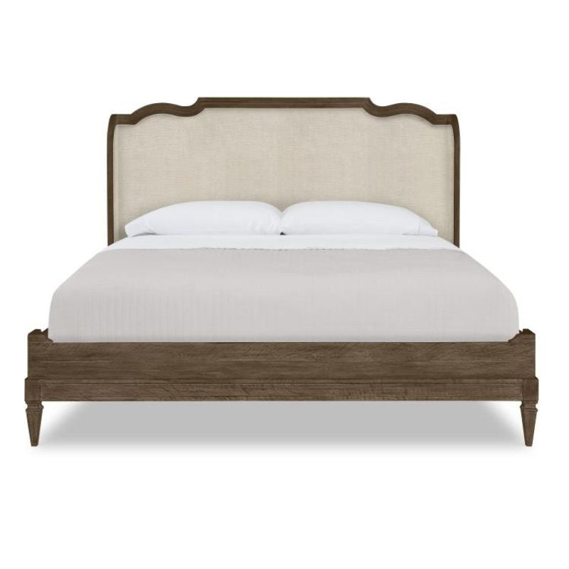 Bed with wooden frame and upholstered headboard on a white background