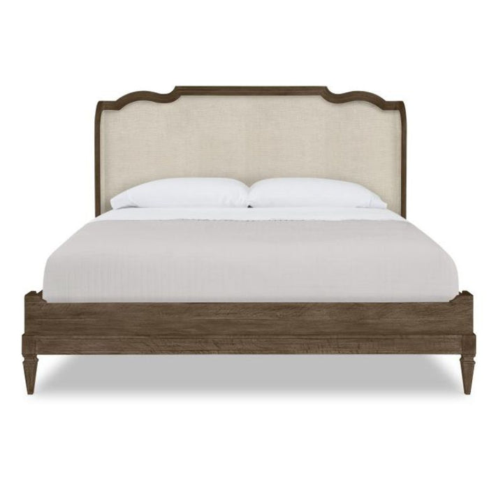 Bed with wooden frame and upholstered headboard on a white background