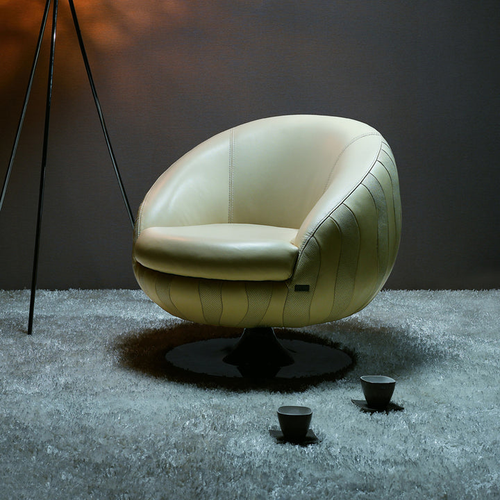 Modern beige chair on a textured gray floor with a dark background