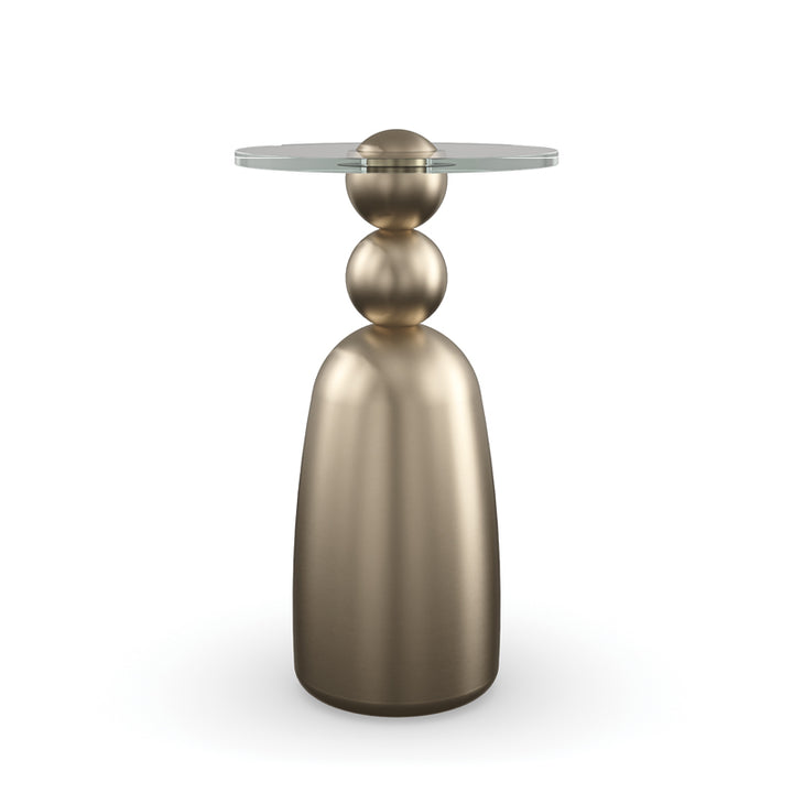Bronze side table with a round glass top on a white background